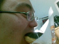 The unglamorous shot of me biting into an oreo doughnut