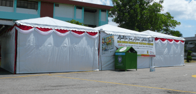 White huts with a recyling bin
